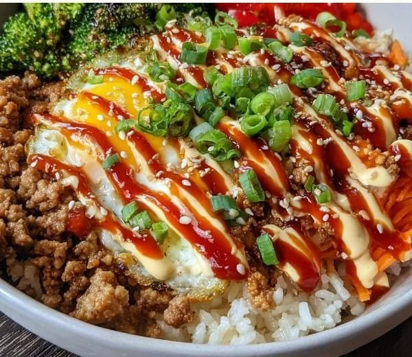Bang bang ground turkey rice bowls served with fresh vegetables and sauce