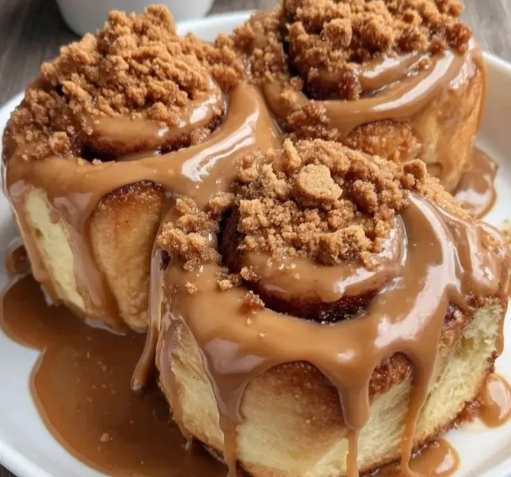Biscoff cookie cinnamon rolls topped with a creamy glaze