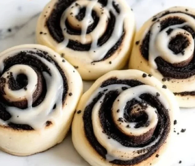 Delicious Cookies and Cream Cinnamon Rolls topped with cream and cookie crumbs