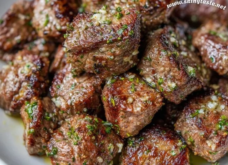 Garlic butter air fryer steak bites served on a plate
