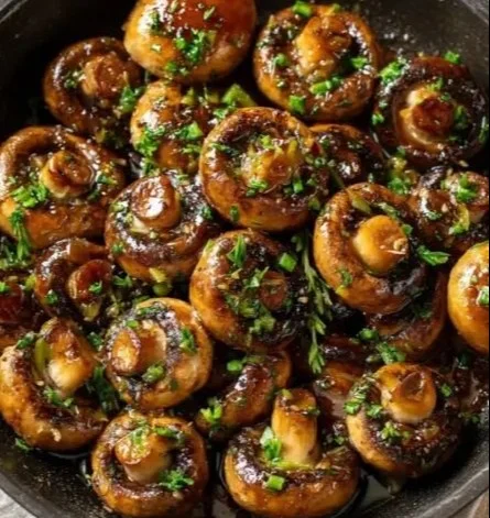 Plate of Garlic Butter Soy-Glazed Mushrooms garnished with herbs