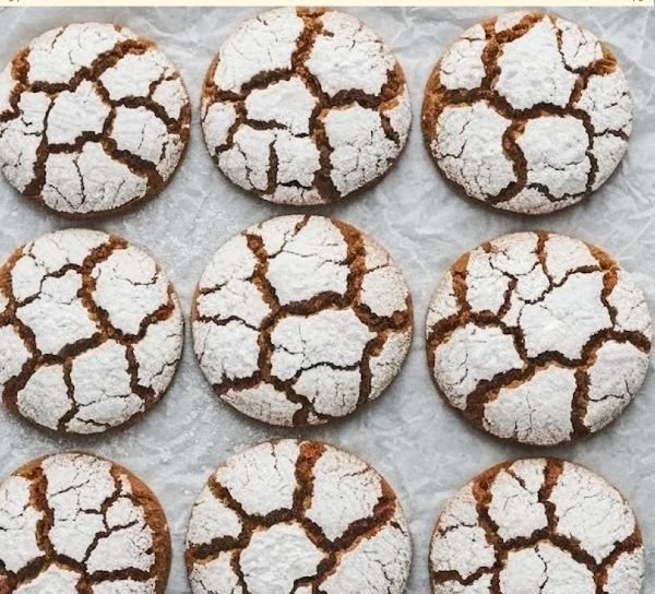 Delicious gingerbread crinkle cookies with powdered sugar on top.