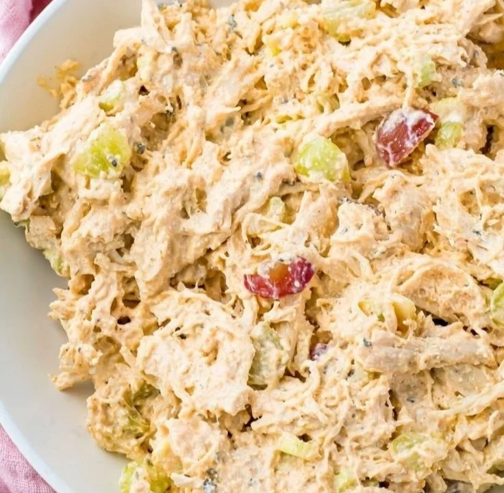 High protein cottage cheese chicken salad in a bowl garnished with herbs.