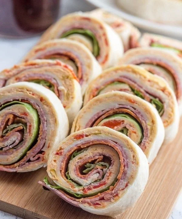 Plate of colorful Italian Pinwheels rolled with savory ingredients