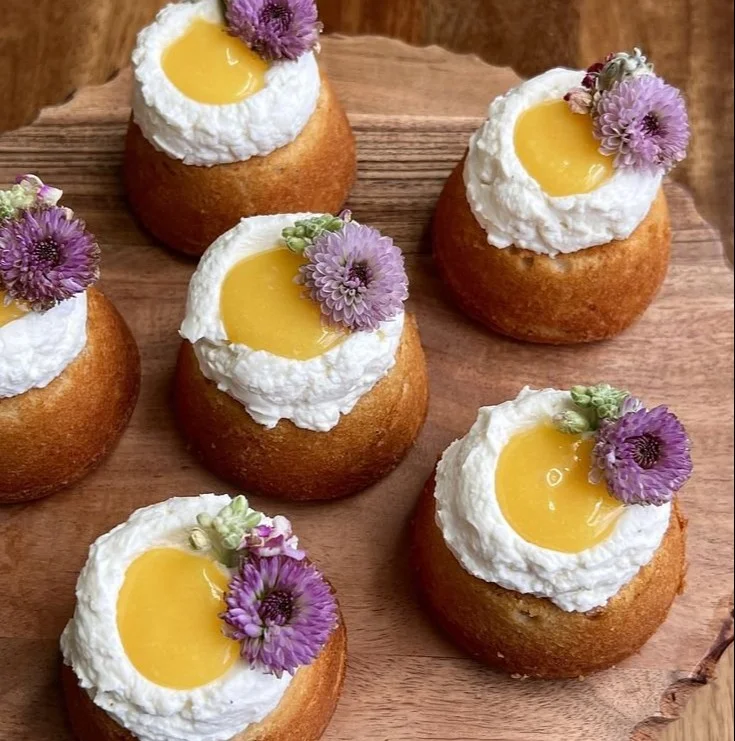 Mini brown butter lemon cakes topped with lemon zest and powdered sugar.