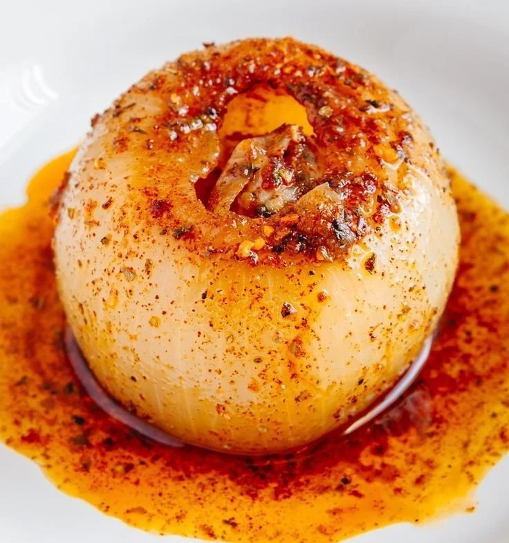 A pot of onion boil with fresh onions and herbs, promoting health benefits.