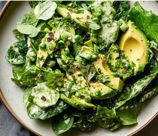 Bowl of Refreshing Green Goddess Salad with vibrant greens and dressing