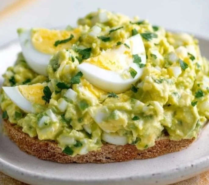 Mediterranean avocado egg salad with fresh ingredients in a bowl