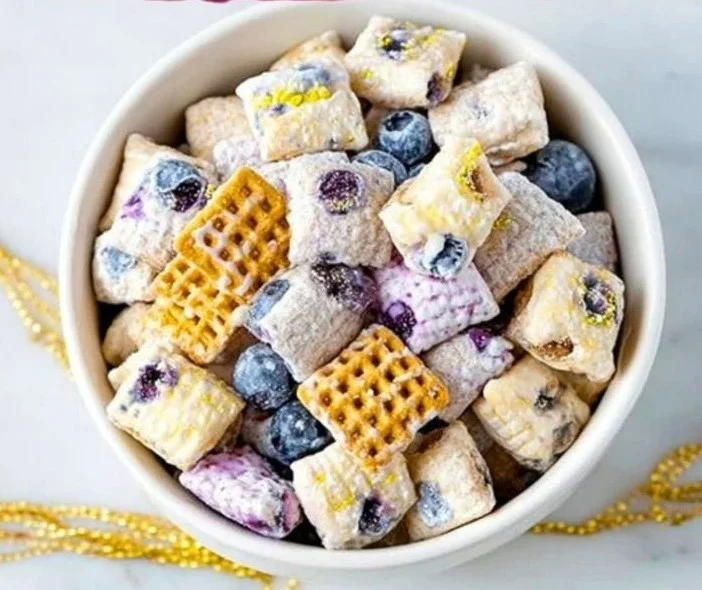Blueberry Lemon Cheesecake Puppy Chow Treat with blueberries and lemon zest