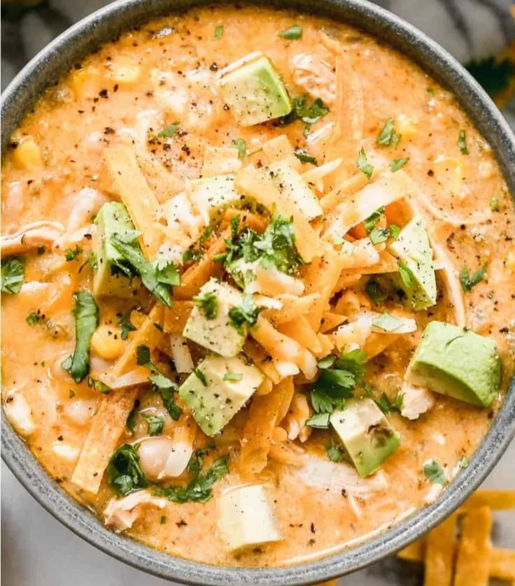 Delicious bowl of white chicken chili topped with cilantro and avocado