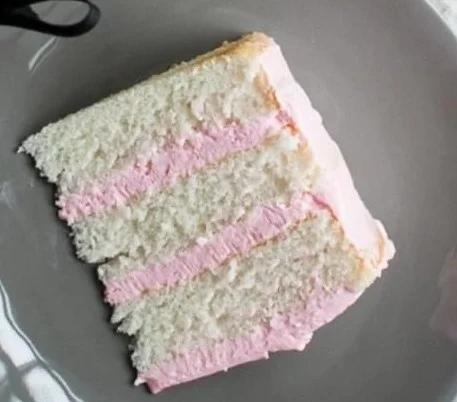 Delicious homemade Almond Cake topped with slivered almonds and frosting