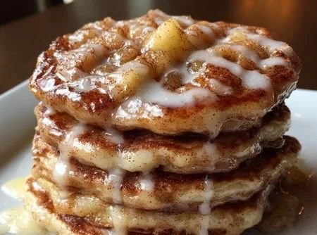 Delicious homemade apple fritter pancakes stacked on a plate