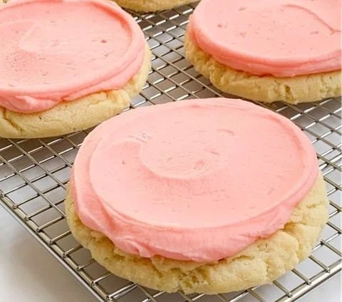 Delicious Crumbl Pink Sugar Cookies on a plate, showcasing their pink frosting.