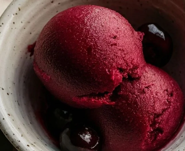 Delicious homemade Cherry Sorbet served in a bowl with fresh cherries on top