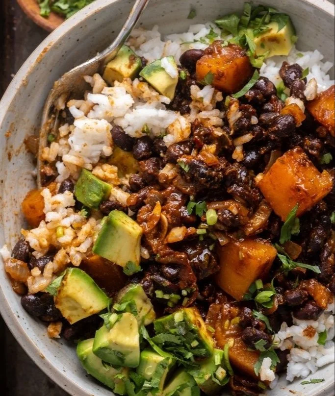Serving of chipotle roasted butternut squash with black beans on a plate.