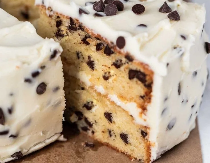 Delicious Chocolate Chip Cake with a slice cut out, showcasing its moist texture.