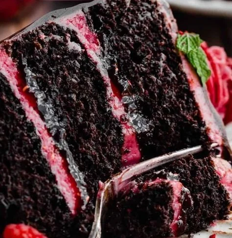 Deliciously layered Chocolate Raspberry Cake with fresh raspberries