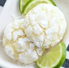 Coconut Key Lime Crinkle Cookies on a plate with a refreshing lime garnish