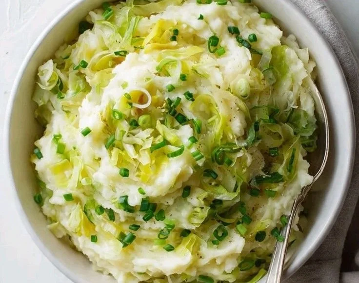 Delicious homemade colcannon dish served on a plate with greens