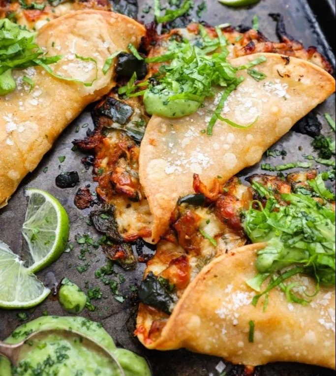 Crispy poblano chicken tacos plated with fresh toppings