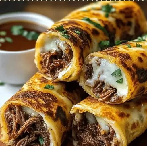 French Dip Tortilla Roll Ups served with dipping sauce