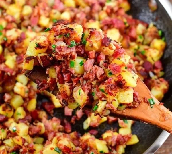 Delicious homemade corned beef hash served on a plate with eggs