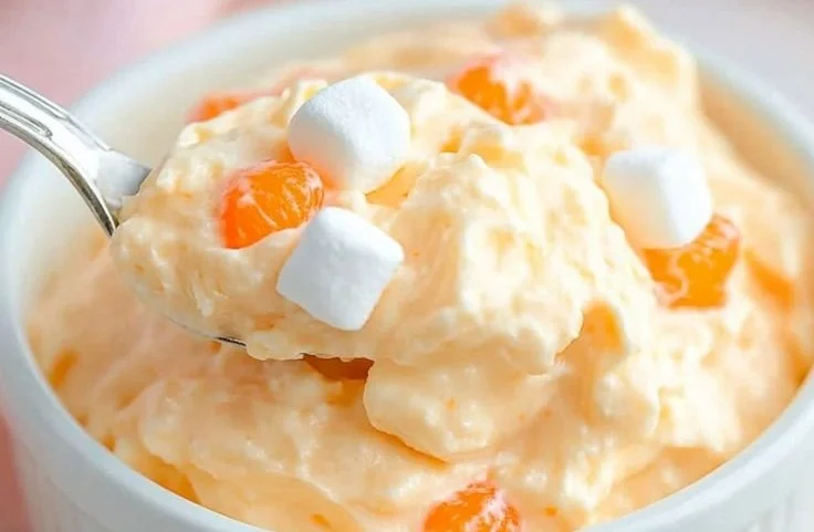 Delicious Greek Yogurt Orange Fluff dessert served in a bowl.