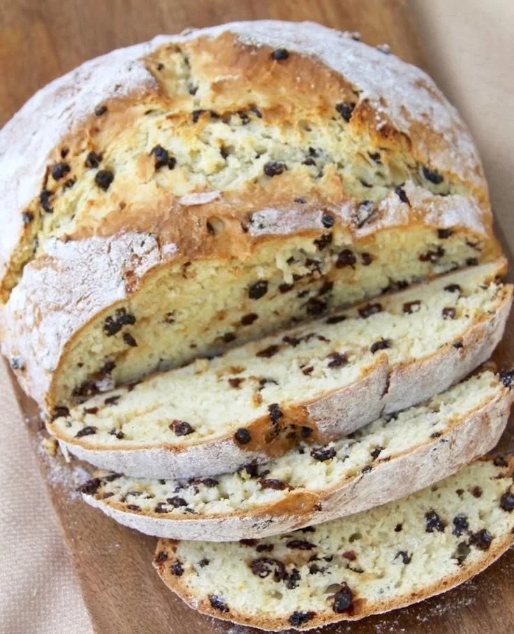 Freshly baked Irish Soda Bread loaf on a wooden table