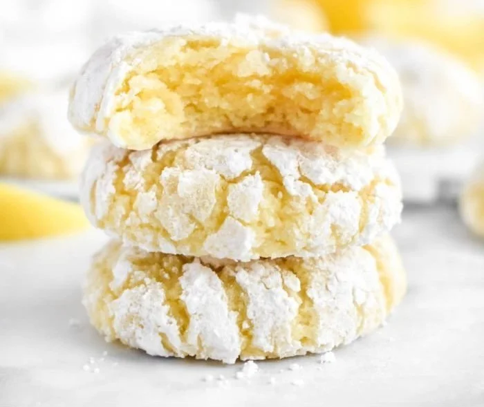 Freshly baked Lemon Crinkle Cookies with a powdered sugar coating