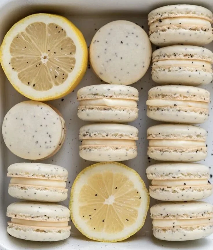 Lemon poppy seed macarons on a decorative plate