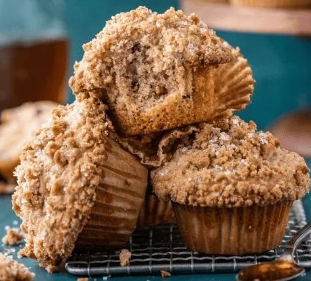 Freshly baked Maple Pecan Muffins on a rustic wooden table.