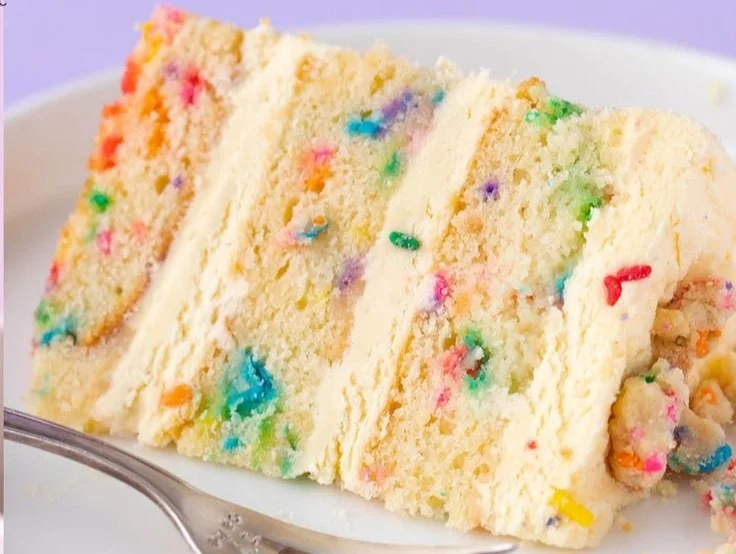 Delicious Milk Bar birthday cake decorated with colorful sprinkles and candles.