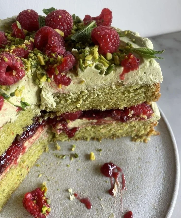 Delicious Pistachio Raspberry Cake with vibrant raspberry frosting and pistachio garnish.