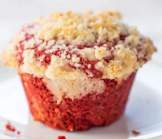 Freshly baked red velvet cream cheese muffins on a cooling rack