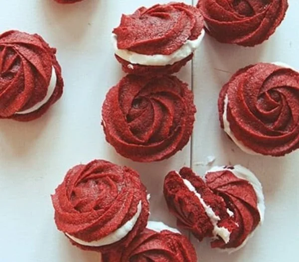 Red Velvet Rose Sandwich Cookies with cream filling on a decorative plate
