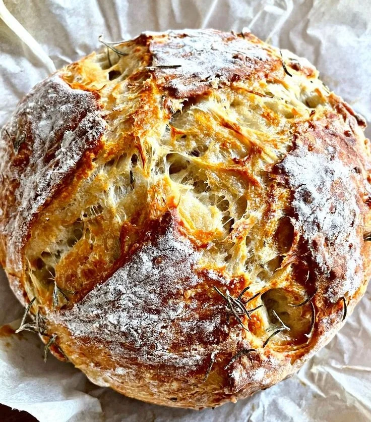 Freshly baked Rosemary Parmesan Artisan Bread with herbs and cheese