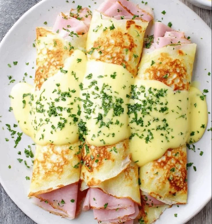 Savory breakfast crepes filled with fresh ingredients and served on a plate