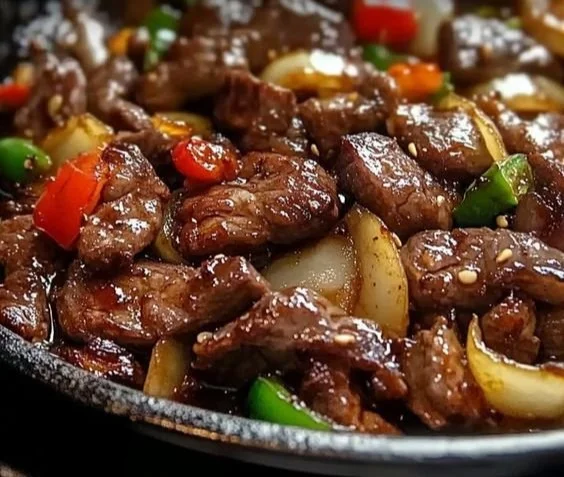 Sizzling Chinese pepper steak with onions served on a plate
