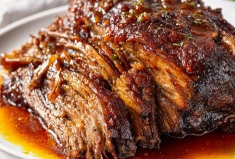 Delicious slow cooked beef brisket served on a plate with sides