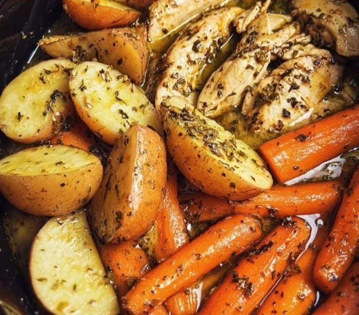 Slow cooker garlic butter chicken simmering with colorful veggies