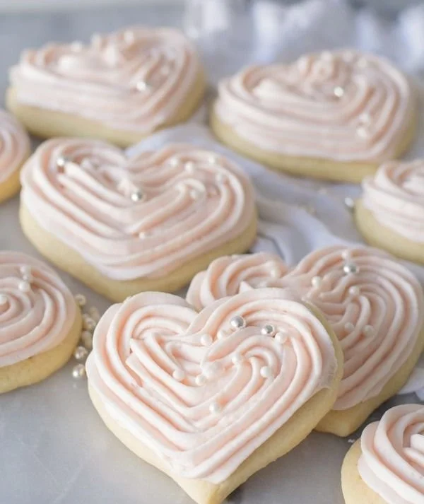 Soft sour cream sugar cookies with cream cheese frosting on a plate