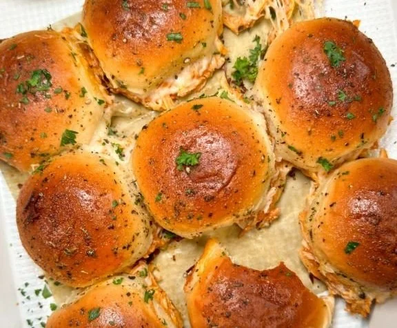 Spicy Buffalo Chicken Sliders served on a plate with fresh toppings