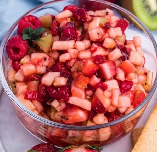 Sweet fruit salad served with cinnamon sugar tortilla chips, a delicious treat.