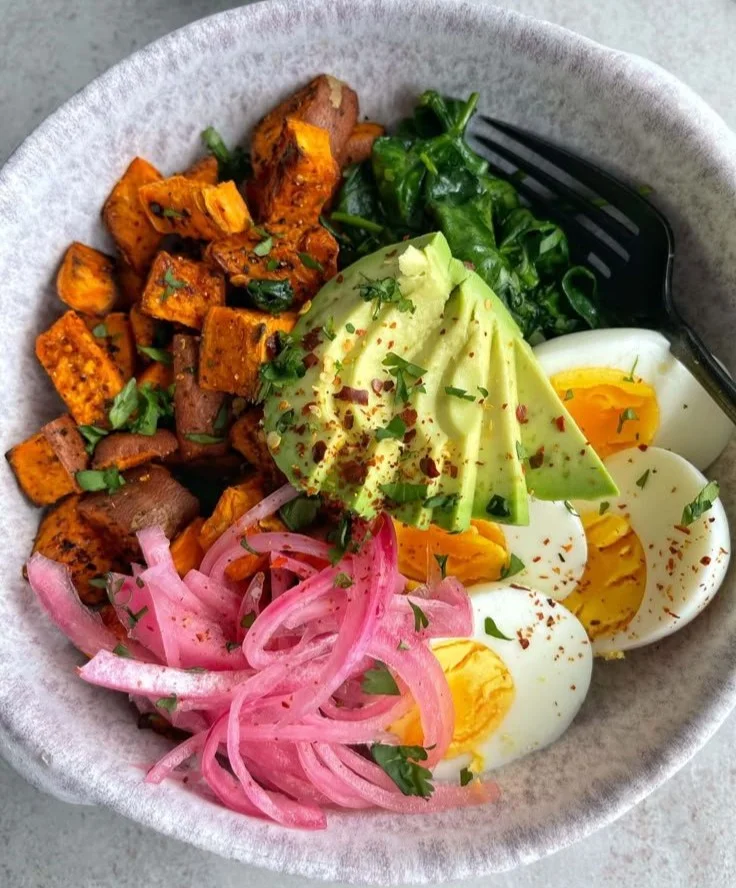 Healthy sweet potato breakfast bowl topped with nuts and seeds