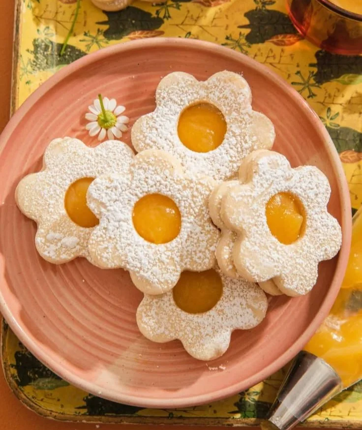 Vegan lemon curd shortbread cookies arranged on a plate