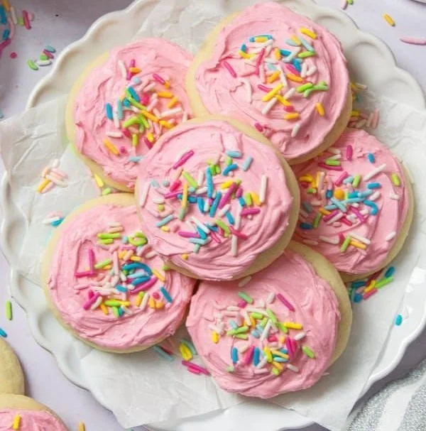 Walmart sugar cookies decorated with colorful buttercream frosting on a plate.