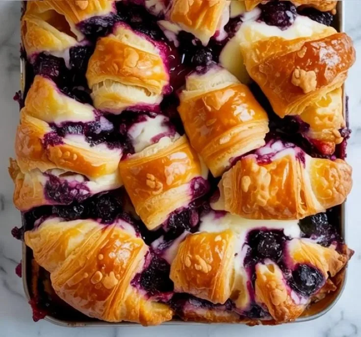 Blueberry Cream Cheese Croissant Casserole baked dish with fresh blueberries and cream cheese