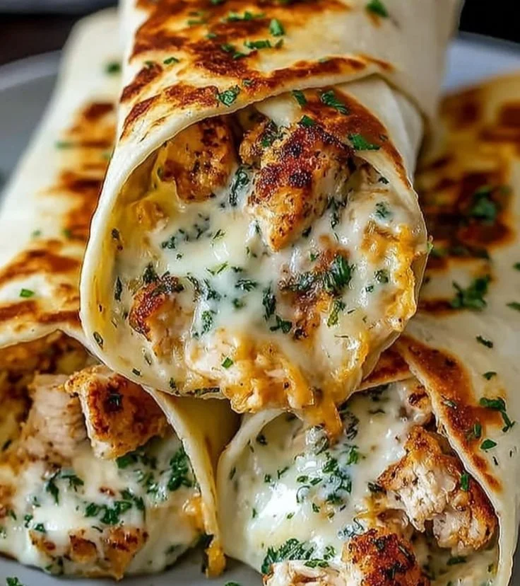 Deliciously cheesy garlic chicken wraps served with fresh ingredients