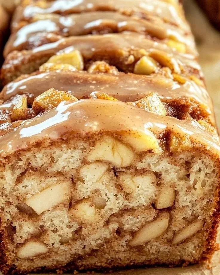 Delicious slice of cinnamon apple bread with apples and cinnamon on display
