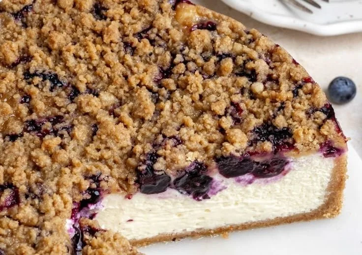 Delicious creamy blueberry cheesecake topped with fresh blueberries